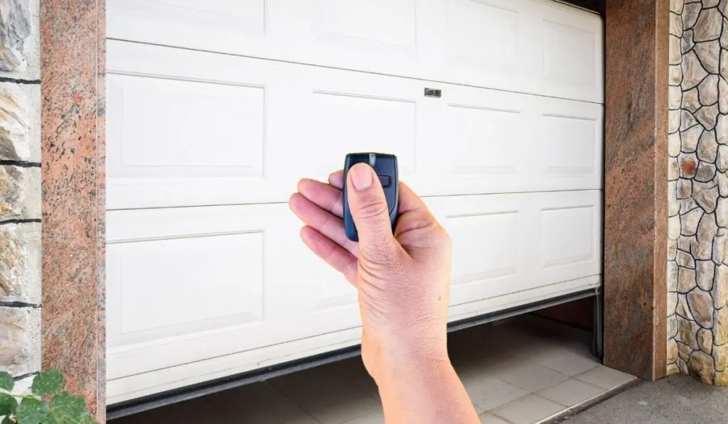 Garage Door and Hand Holding the Remote Key