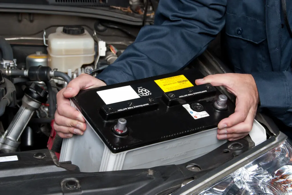 A mechanic replacing the car battery
