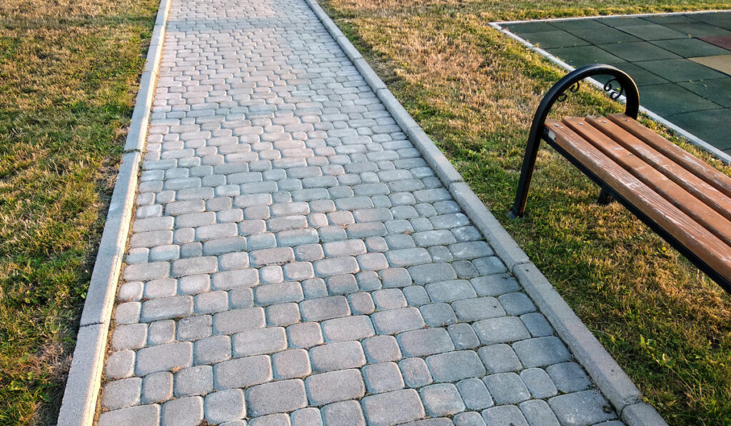 Close-up of slab stone paved path way at house yard