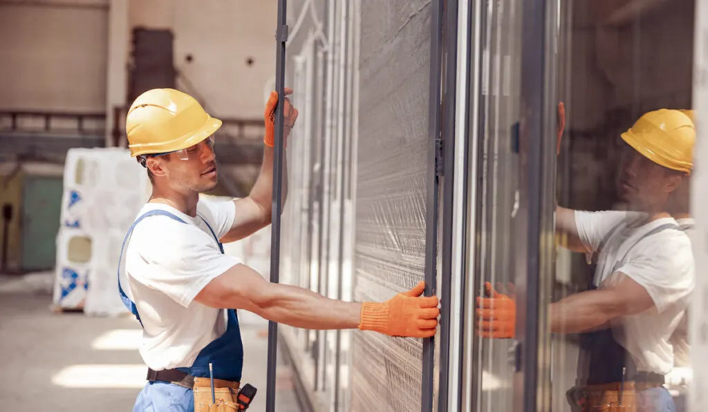 Male worker installing sliding door  