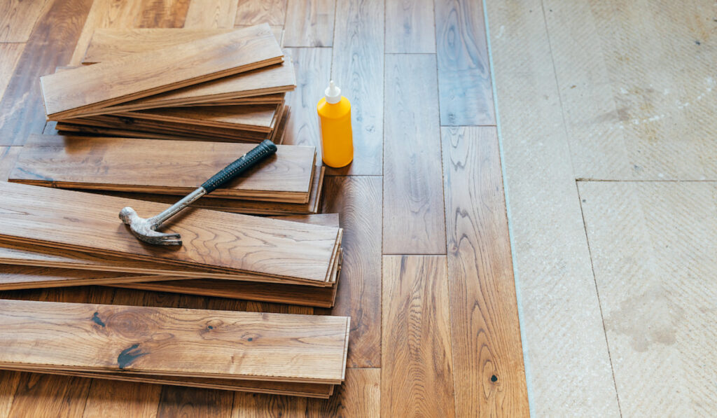 Solid oak wood flooring material and hammer