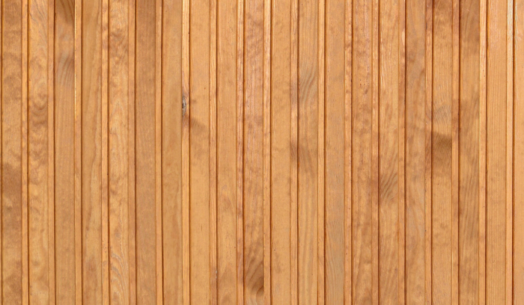 close up of brown wooden fence panels many vertical