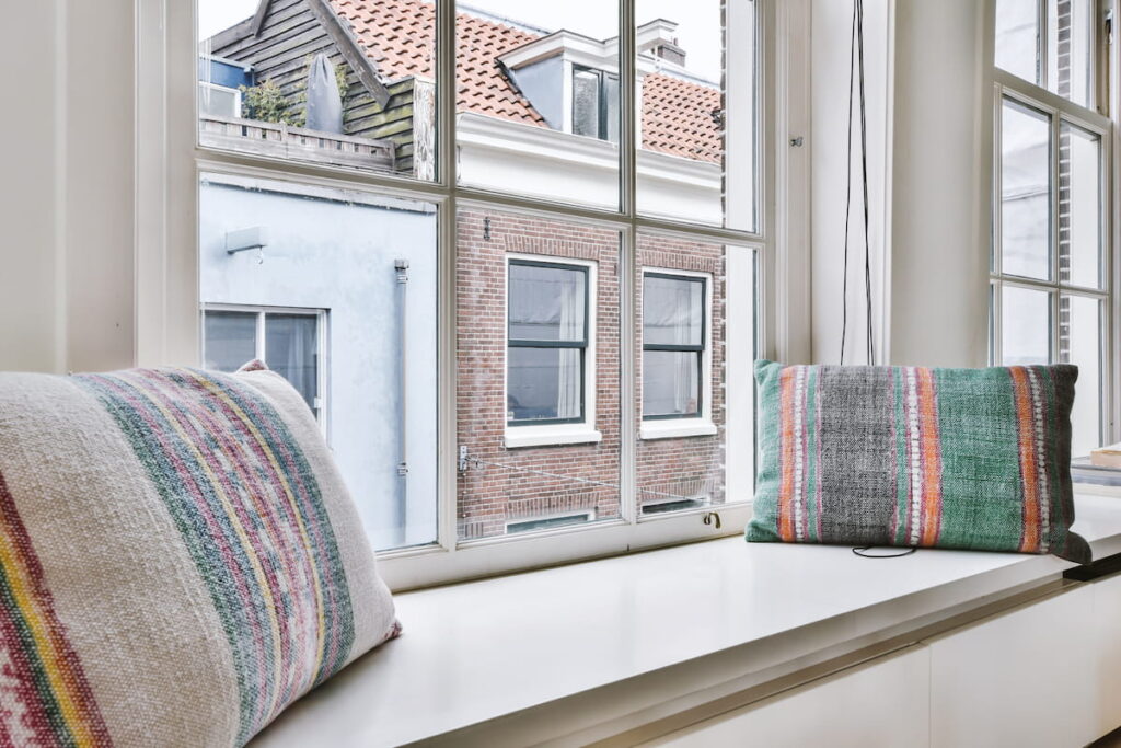 cushions on windowsill near window