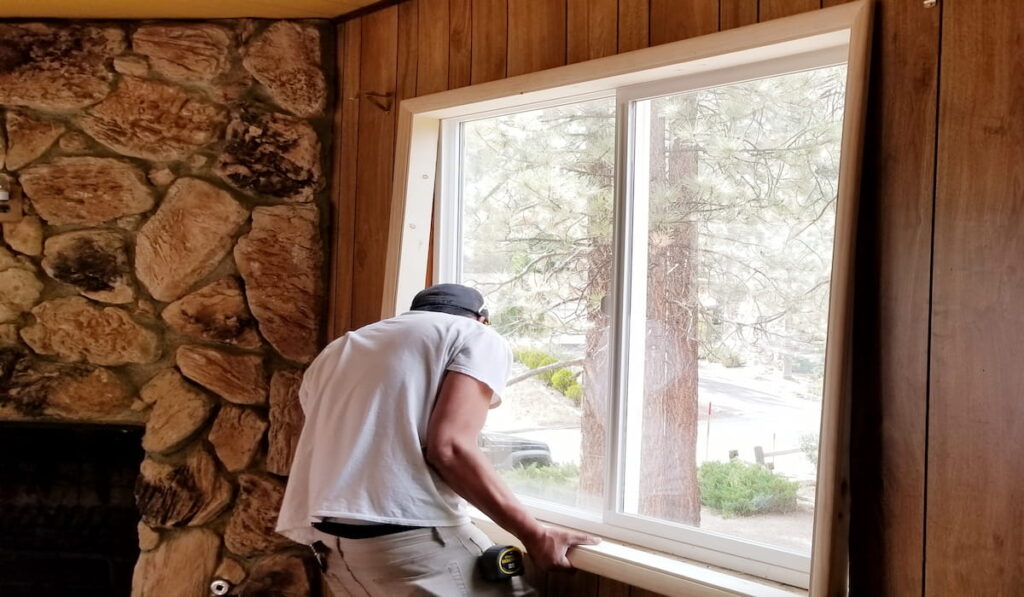 man doing window installation at home