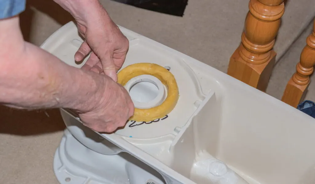 man installing a new toilet 