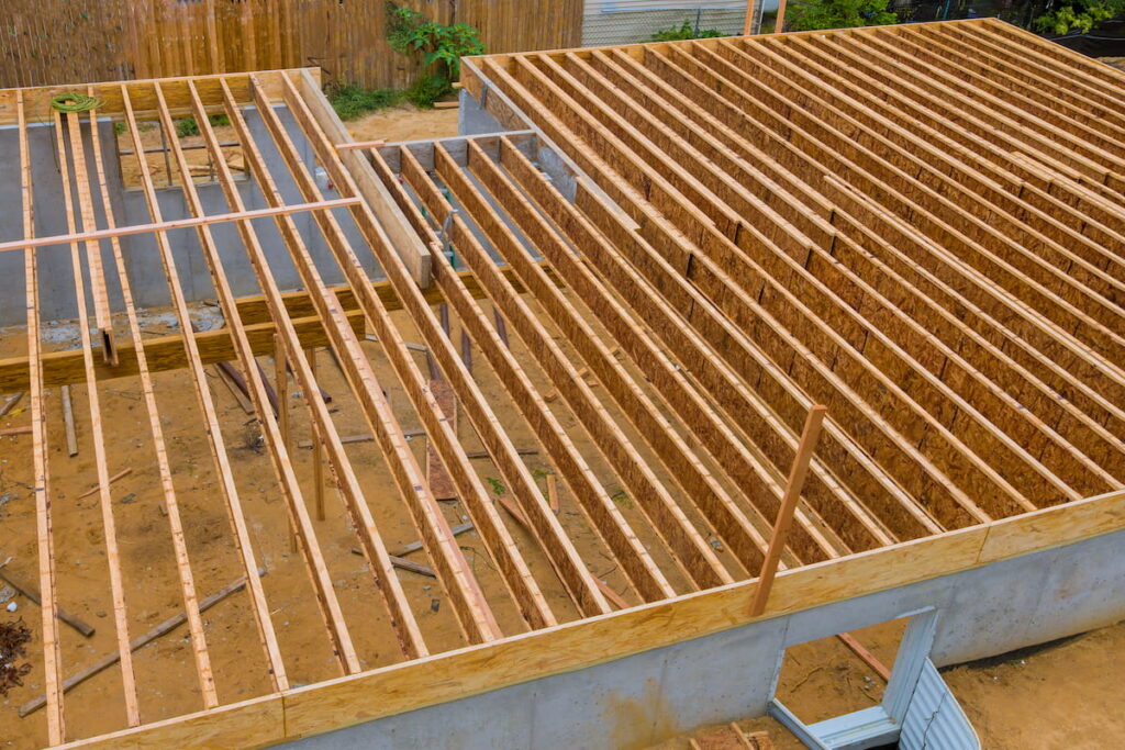 House framing floor construction showing massive solid wood joists trusses
