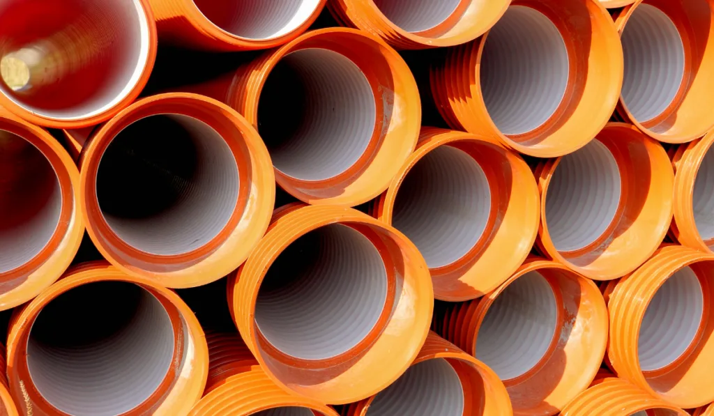 Pvc pipes and tubes stacked in the factory warehouse