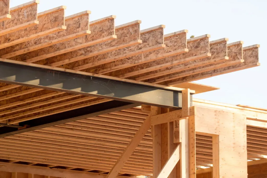 engineered wood joists on a steel beam in a house under construction