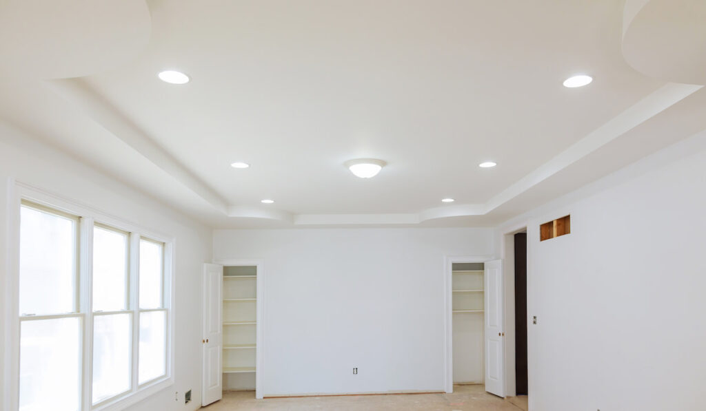 new home construction interior drywall and finish details with white lights installed