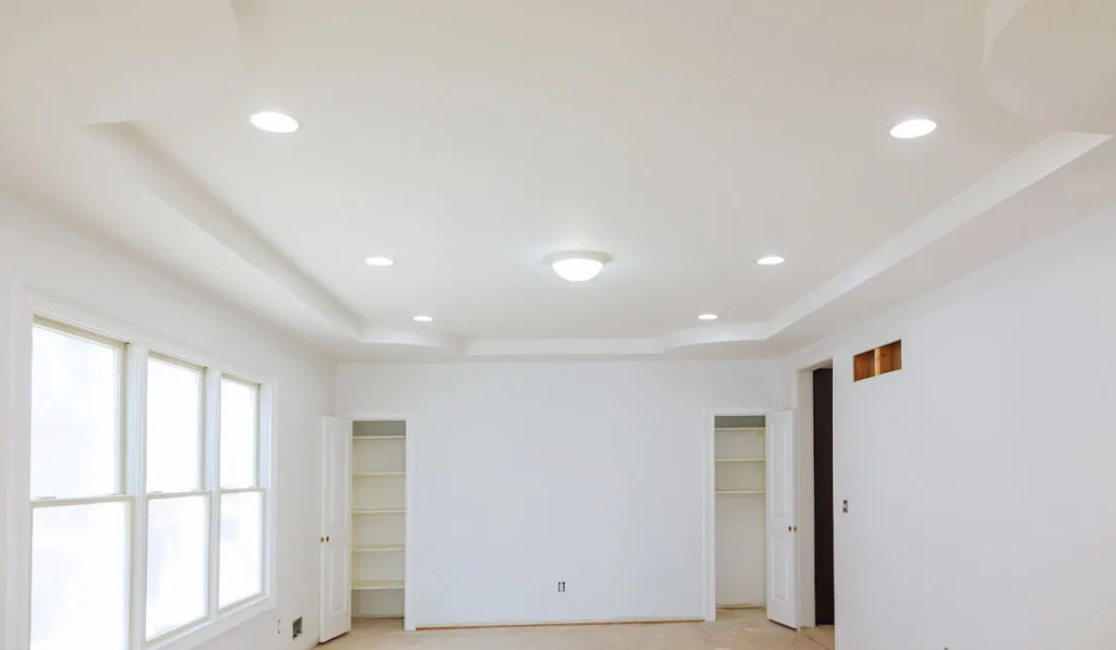 new home construction interior drywall and finish details with white lights installed