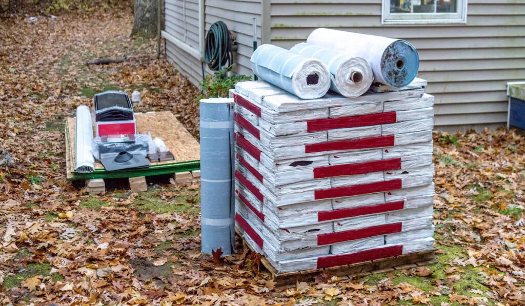 pallets hold all the roofing supplies needed to re-shingle a new roof on a home 