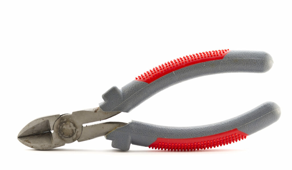 An old used cutting pliers on white background.