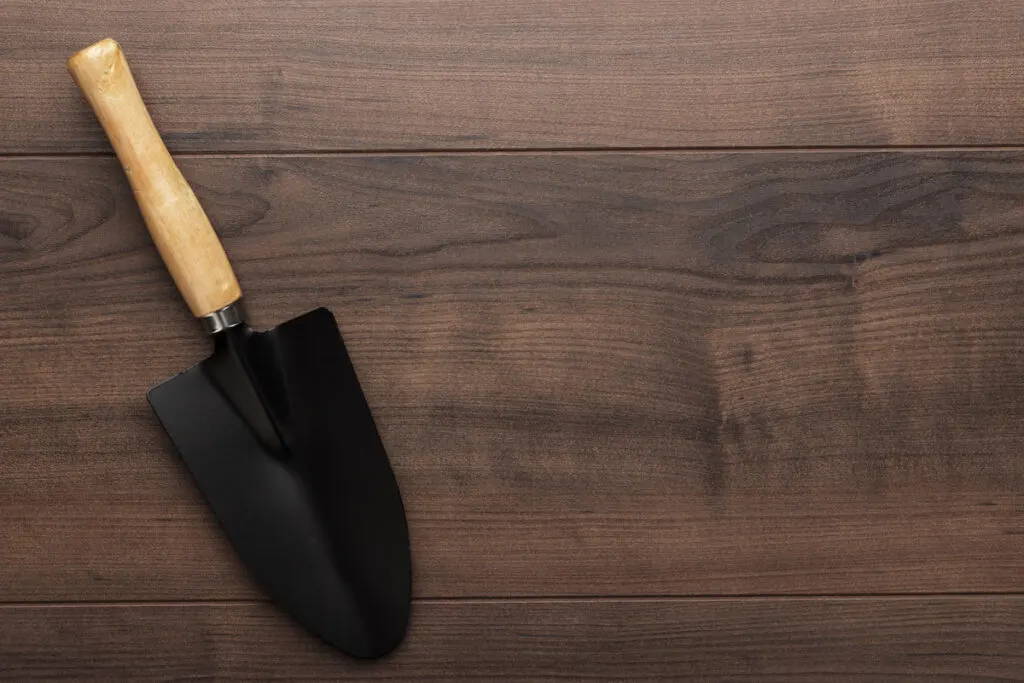Black Gardening handheld Shovel On The Wooden Table
