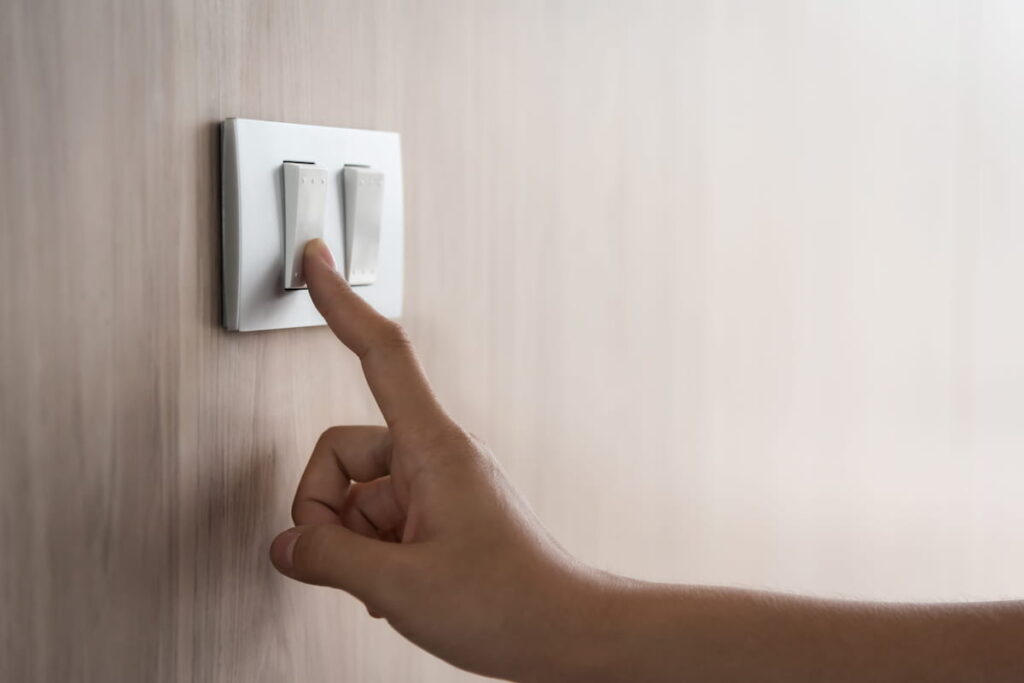 Close up of male finger is turn on or off on light switch