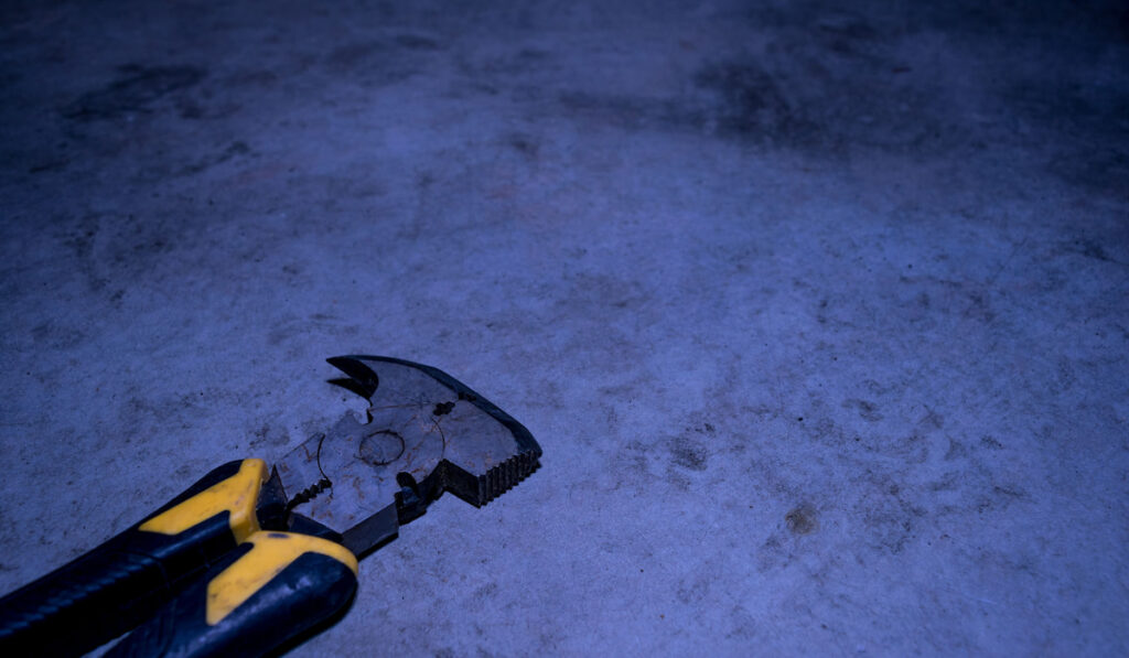 Fencing Pliers On Concrete Floor on dark background
