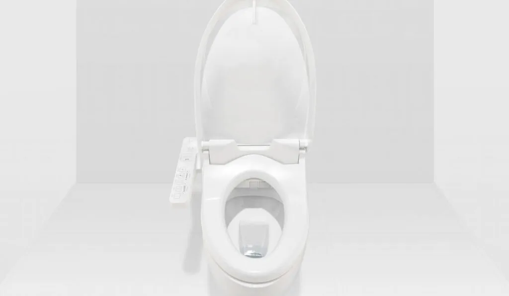 Interior of modern restroom are ceramic toilet bowl with electronic control and sensors for automatic flushing