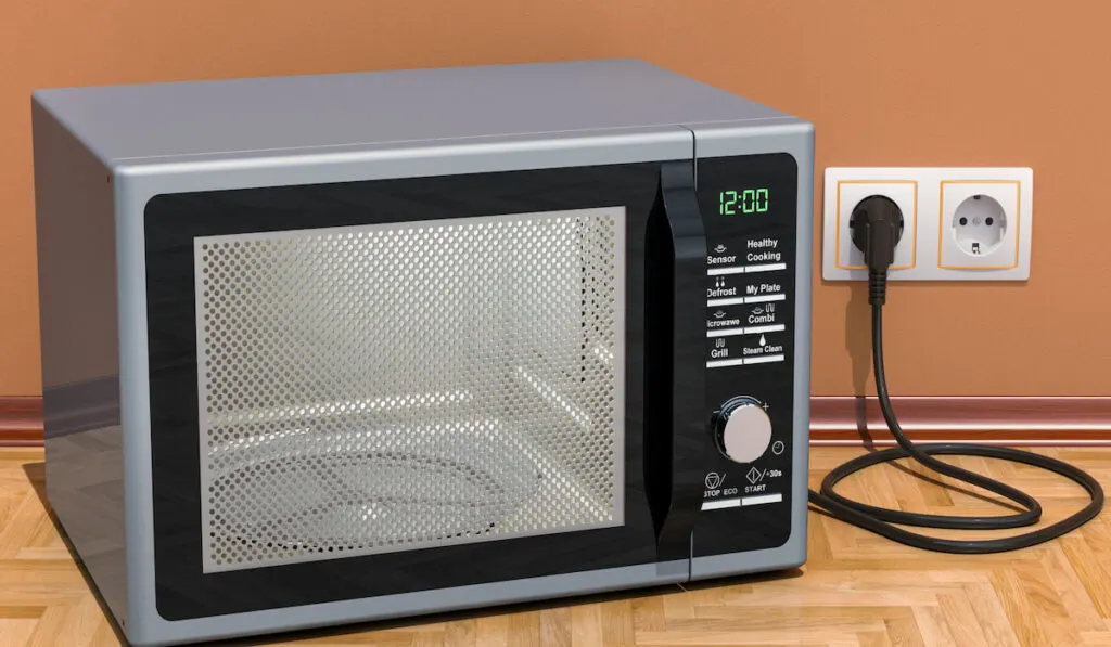 Modern Microwave plugged in from wall outlet