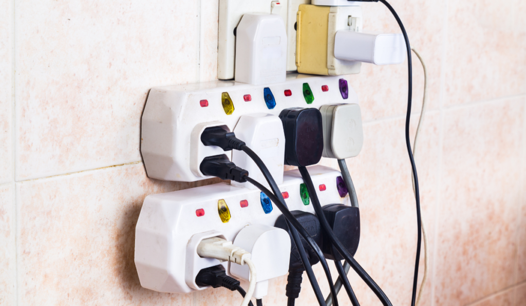 Multiple electricity plugs on adapter risk overloading and danger