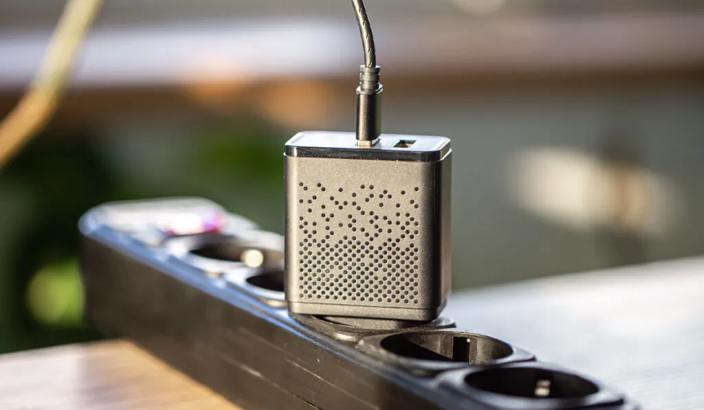 USB charging for gadgets plugged in in an extension on a blurred background 