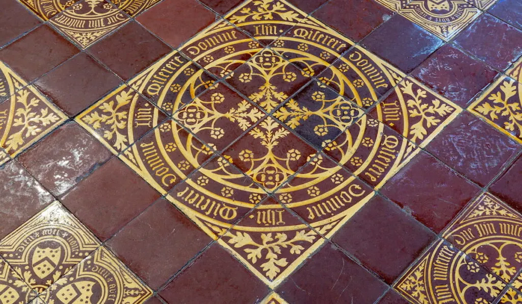 Victorian encaustic tiles on the floor of the High Altar in St Mary De Crypt 