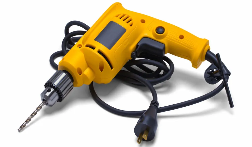 Yellow Corded Electric Power Drill on white background