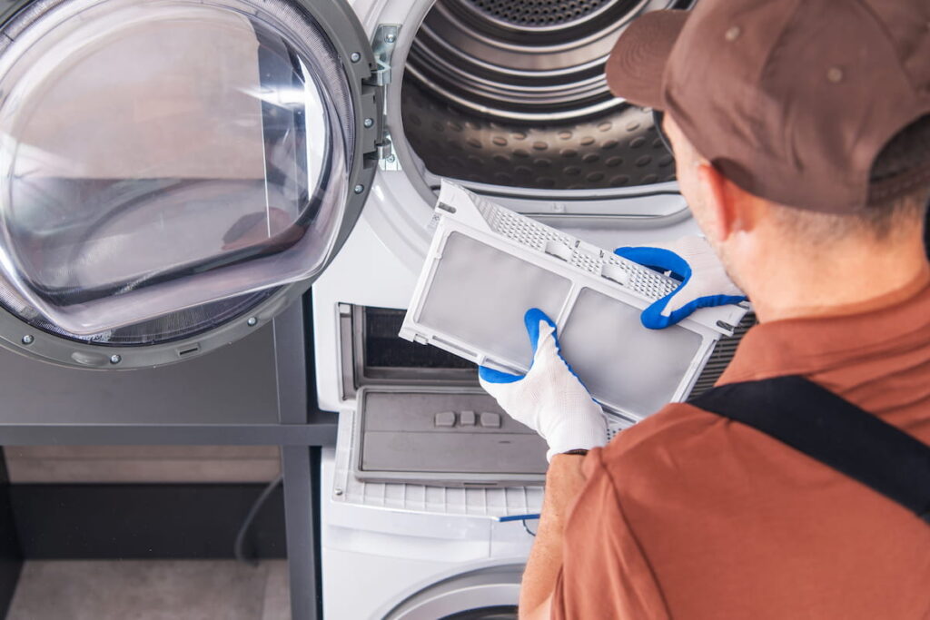 man cleaning washer and dryer filter