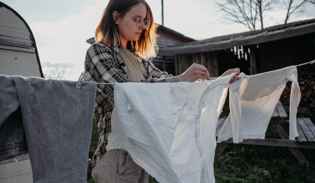 woman hanging laundry outside