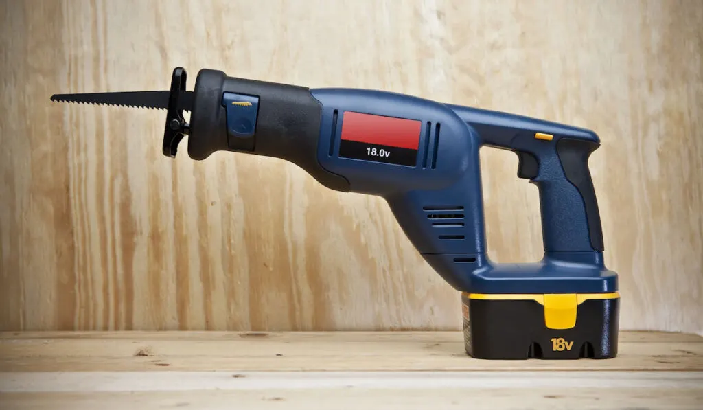 Cordless Reciprocating Saw on wooden background