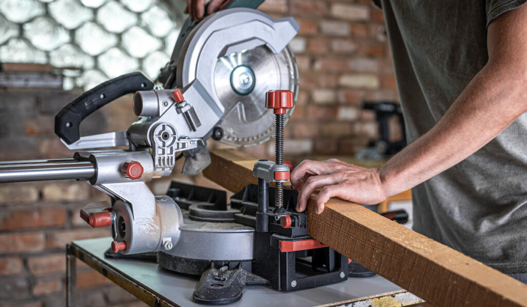 Professional carpenter working with a miter saw