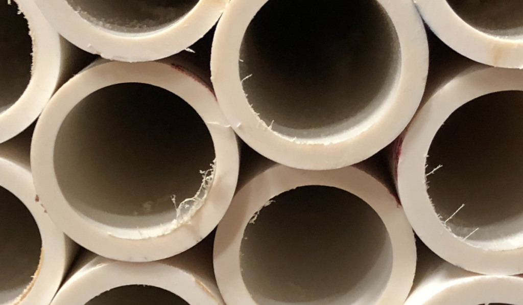 A wall of large white pvc pipes at warehouse store