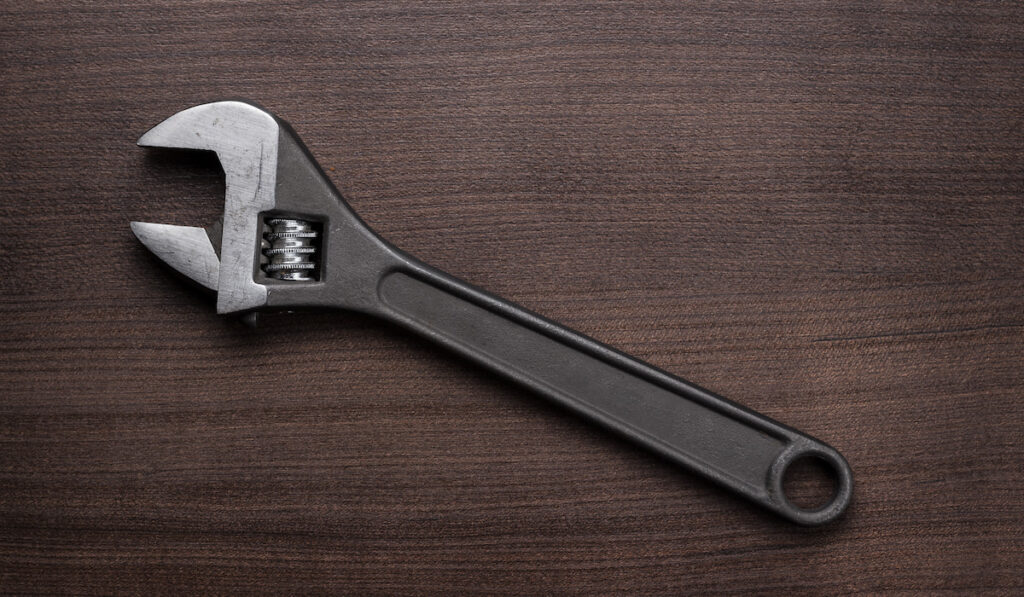 Adjustable wrench on wooden table 