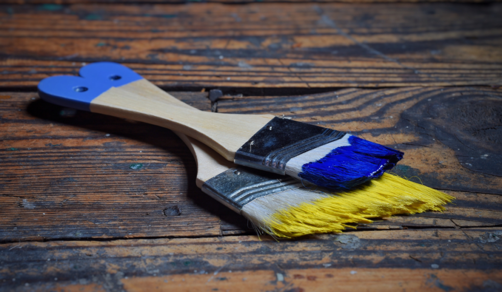 Paint brushes on the wooden floor
