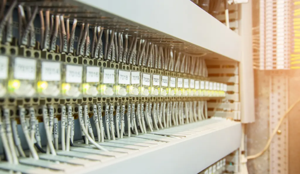 Terminal and wiring cables with electric relays inside the cabinet.
