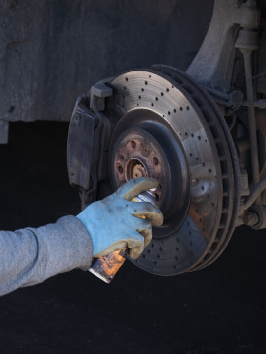 Man cleanig brake using brake cleaner - ss221110