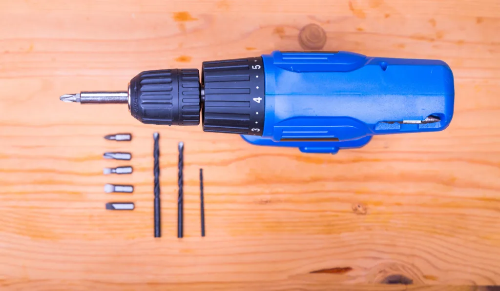 screwdriver set with bits on wooden background