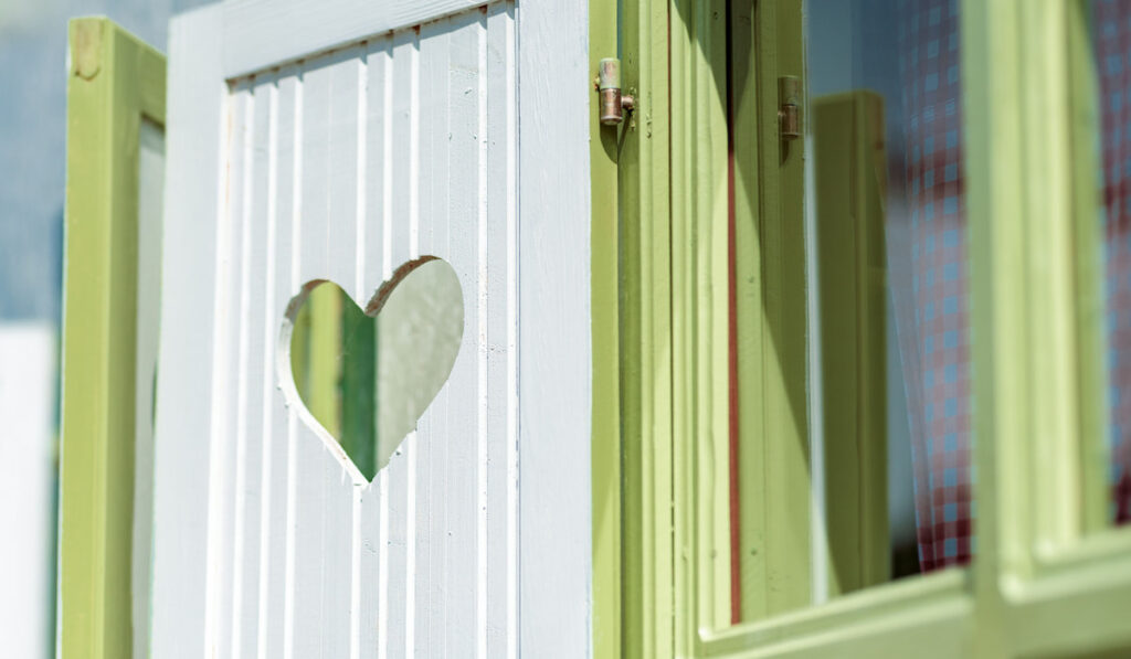 Heart-shaped cutout on window wooden shutter