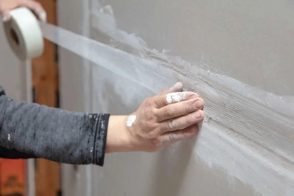 applying mesh drywall tape carefully