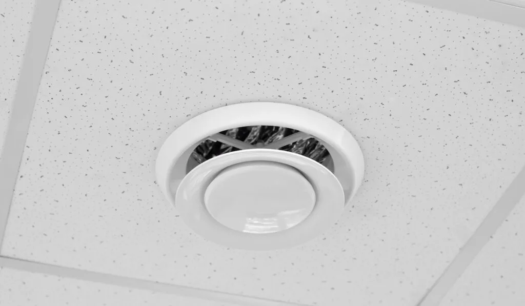 Round ventilation duct on the ceiling. Modern ventilation built into the ceiling