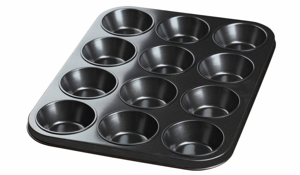 Black 12 cup muffin tin on white background