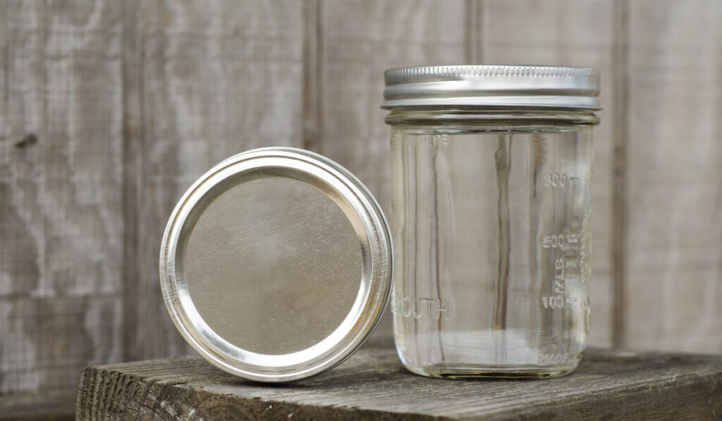 Rustic Mason Jars on wooden table on wooden background