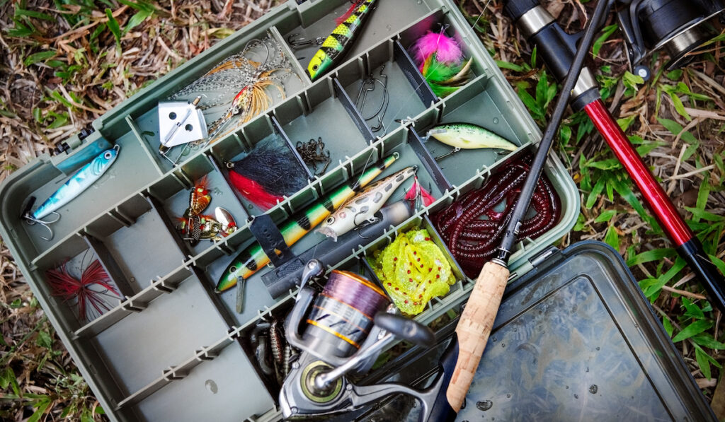 Tackle box with fishing tools on the ground